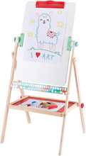 Load image into Gallery viewer, Image of unfolded easel. The base tray has the included art supplies laid out, and on the easel is a clipped piece of paper with a drawing of a llama.