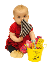 Load image into Gallery viewer, Image of a baby playing with Baby Paper, next to a bucket of more Baby Paper.  The Baby Paper is about the size of the child's head.