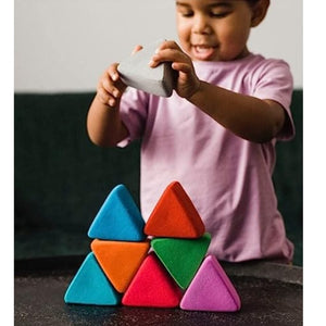 A child stacking the triangles into a larger triangle!