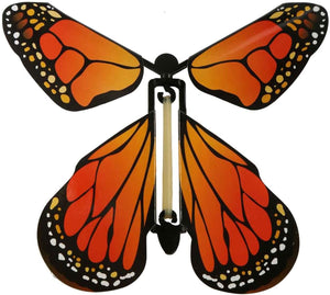 Picture of the Monarch Butterfly Variant.  The butterfly is an ombre of oranges lighter closer to the body.  The outer edges of the wings are black with small white and orange dots.
