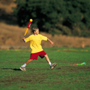 A child about to throw the foxtail, holding it by the tail and rotating it to build momentum. 