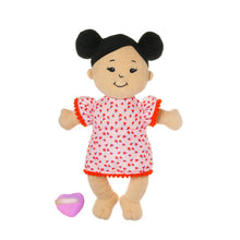Load image into Gallery viewer, Baby Stella Light Beight with Black Buns outside of packaging.  The doll has black embroidered eyes and a smile.  She is where an orange dress with scalloped trim and oranges patterned on the cloth.  
