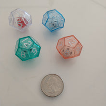 Load image into Gallery viewer, 12 sided dice in red, blue, white and teal colors, compared to the size of a quarter.

