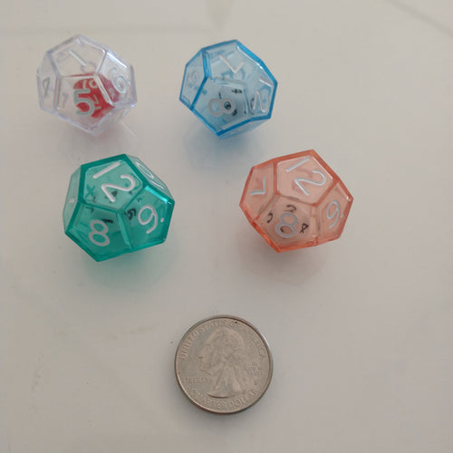 12 sided dice in red, blue, white and teal colors, compared to the size of a quarter.