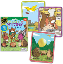 Load image into Gallery viewer, Box cover and three sample cars.  In one a yellow bird carries a pair of cherries over a city park in fall.  Another shows a squirrel mixing batter in a bakery, wearing an apron and chef hat.   The last sample card shows three porcupines in a fen.  The one closest to the viewer is blowing up a yellow balloon, a second watches, and the third is laying down in the background.  A yellow plane flies overhead. 
