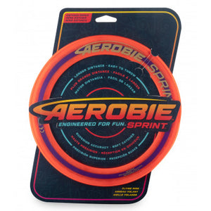 Aerobie 10" ring in packaging.  An orange disc with black cardboard backing. 
