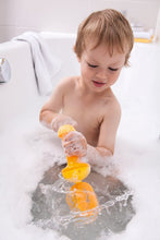 Load image into Gallery viewer, A kid whisking up some bubbly bath water in the tub
