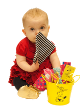 Load image into Gallery viewer, Image of a baby playing with Baby Paper, next to a bucket of more Baby Paper.  The Baby Paper is about the size of the child&#39;s head.  
